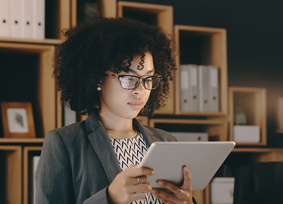 Cropped shot of a businesswoman using a digital tablet at the office